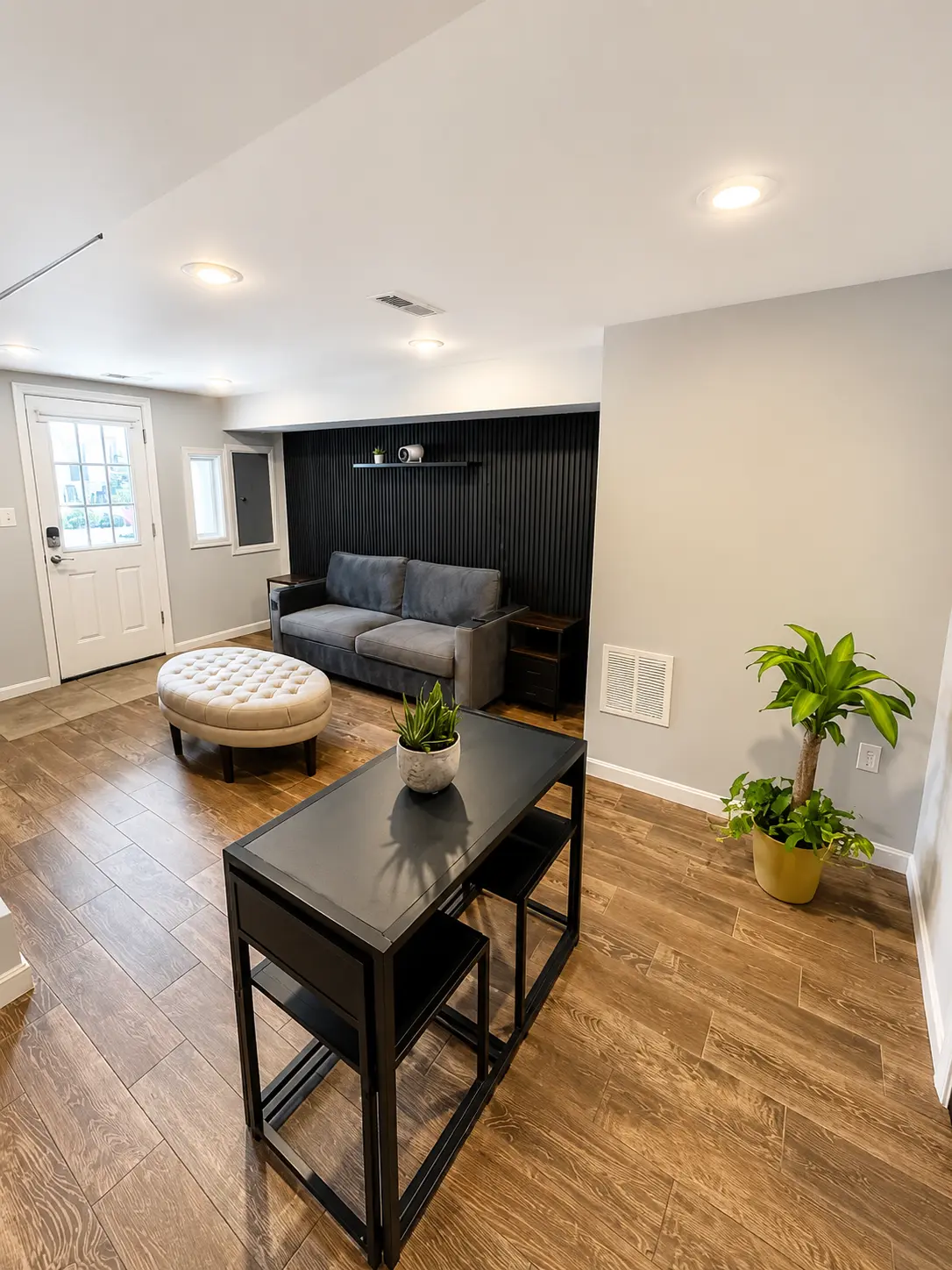 Bright private studio with sofa, coffee table, and dining area