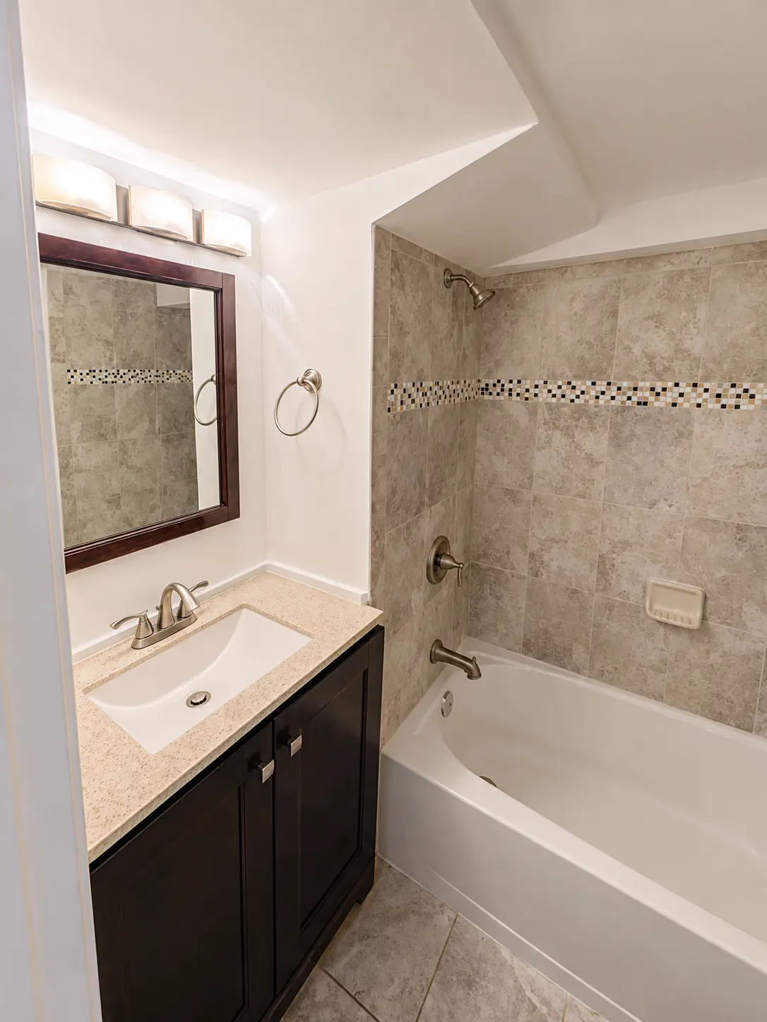 Private full bathroom with tiled tub and shower